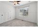 Bright bedroom with neutral carpet, modern trimwork, and a view from the window at 4046 Water Hole Ct, Douglasville, GA 30135