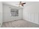 Bright bedroom with neutral carpet, modern trimwork, and a view from the window at 4046 Water Hole Ct, Douglasville, GA 30135