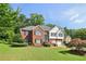 Two-story home with a well-manicured lawn and mature trees at 4046 Water Hole Ct, Douglasville, GA 30135