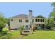 Back exterior showcasing a screened porch, patio, and landscaped yard at 4046 Water Hole Ct, Douglasville, GA 30135