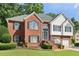 Traditional two-story brick home with a well-maintained lawn and landscaped front yard at 4046 Water Hole Ct, Douglasville, GA 30135
