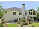 Rear exterior view featuring a patio area, manicured lawn, and access to the screened-in porch at 4046 Water Hole Ct, Douglasville, GA 30135