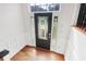 Bright foyer with hardwood floors, white wainscoting, and a front door with glass panels at 4046 Water Hole Ct, Douglasville, GA 30135