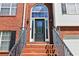 Inviting front entrance with a brick stairway and front door with glass panel at 4046 Water Hole Ct, Douglasville, GA 30135