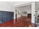 Open-concept living room with dark wainscotting and hardwood floors at 4046 Water Hole Ct, Douglasville, GA 30135