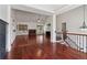 Open concept living room featuring hardwood floors, fireplace, and a staircase at 4046 Water Hole Ct, Douglasville, GA 30135