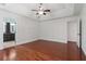 Spacious bedroom featuring a ceiling fan, wood floors, and access to the bathroom at 4046 Water Hole Ct, Douglasville, GA 30135