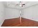 Spacious bedroom featuring a ceiling fan, wood floors, and access to the bathroom at 4046 Water Hole Ct, Douglasville, GA 30135