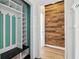 Mudroom features a built-in storage bench with white shelves, a black bench, and mint green accents at 4046 Water Hole Ct, Douglasville, GA 30135