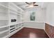 Home office featuring built-in shelves, wood floors, and wainscoting at 4046 Water Hole Ct, Douglasville, GA 30135