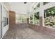 Bright and airy sunroom featuring brick walls, tile flooring, and large windows with nature views at 4046 Water Hole Ct, Douglasville, GA 30135