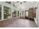 Cozy sunroom with brick accents and large windows overlooking the wooded backyard at 4046 Water Hole Ct, Douglasville, GA 30135