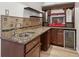 Wet bar featuring granite countertops, wooden cabinets, decorative backsplash, and a wine cooler at 4046 Water Hole Ct, Douglasville, GA 30135