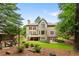 Rear elevation of home featuring backyard, patio, deck and exterior stairs at 5007 Highland Oaks Se Ct, Smyrna, GA 30126