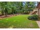 Expansive lawn in backyard featuring mature landscaping and multiple seating areas at 5007 Highland Oaks Se Ct, Smyrna, GA 30126