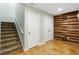 Finished basement featuring carpeted stairs and stained concrete flooring with storage closets and wood accent wall at 5007 Highland Oaks Se Ct, Smyrna, GA 30126