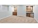 Finished basement featuring carpeted floors, built-in cabinets, and a beverage center with stainless steel appliances at 5007 Highland Oaks Se Ct, Smyrna, GA 30126