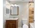 Bathroom featuring a vanity with granite countertops, decorative mirror, and tiled shower at 5007 Highland Oaks Se Ct, Smyrna, GA 30126