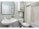 Clean bathroom with white fixtures, vanity with mirror, and shower with tub at 5007 Highland Oaks Se Ct, Smyrna, GA 30126