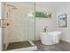 Bathroom featuring a glass enclosed shower with mosaic tile flooring, and a modern soaking tub at 5007 Highland Oaks Se Ct, Smyrna, GA 30126