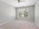 Empty bedroom with neutral walls and carpet with a window overlooking the backyard at 5007 Highland Oaks Se Ct, Smyrna, GA 30126