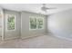Light and airy bedroom with two large windows overlooking the backyard and neutral carpet at 5007 Highland Oaks Se Ct, Smyrna, GA 30126