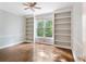 Bright bedroom with hardwood floors, built-in bookshelves, and a large window at 5007 Highland Oaks Se Ct, Smyrna, GA 30126