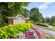 Welcoming entrance to the club featuring colorful landscaping and a brick sign at 5007 Highland Oaks Se Ct, Smyrna, GA 30126