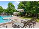 Community pool featuring a waterslide, lounge chairs, and beautifully landscaped surroundings at 5007 Highland Oaks Se Ct, Smyrna, GA 30126