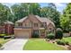 Beautiful brick two-story home with manicured lawn and mature trees in a desirable neighborhood at 5007 Highland Oaks Se Ct, Smyrna, GA 30126