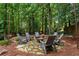 Landscaped backyard with wood burning fire pit, and six Adirondack chairs at 5007 Highland Oaks Se Ct, Smyrna, GA 30126
