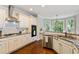Modern kitchen featuring stainless steel appliances, custom cabinets, and plenty of counter space at 5007 Highland Oaks Se Ct, Smyrna, GA 30126