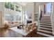 Spacious living room featuring high ceilings, large windows, and a cozy fireplace at 5007 Highland Oaks Se Ct, Smyrna, GA 30126