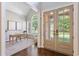 Bright home office with large windows, neutral colors, and vaulted ceilings at 5007 Highland Oaks Se Ct, Smyrna, GA 30126