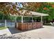 Outdoor poolside bar with brick accents and seating, perfect for entertaining guests at 5007 Highland Oaks Se Ct, Smyrna, GA 30126