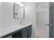 Bathroom vanity with quartz countertop, dark cabinets, and modern lighting at 5007 Highland Oaks Se Ct, Smyrna, GA 30126
