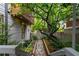 Landscaped backyard featuring a stone path and lush greenery at 670 Willoughby Ne Way, Atlanta, GA 30312