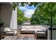 View of a comfortable outdoor seating area with string lights and lush greenery at 670 Willoughby Ne Way, Atlanta, GA 30312