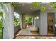 A balcony featuring a cozy daybed, a rug, and an office view through a glass door at 670 Willoughby Ne Way, Atlanta, GA 30312