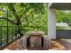 An outdoor dining table with benches surrounded by trees, sitting on a private balcony at 670 Willoughby Ne Way, Atlanta, GA 30312