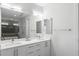 Contemporary bathroom with double vanity, large mirror, and a glass-enclosed shower and tub at 670 Willoughby Ne Way, Atlanta, GA 30312