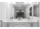 Bright bathroom featuring a double vanity with a large mirror and modern fixtures at 670 Willoughby Ne Way, Atlanta, GA 30312