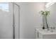 Modern bathroom featuring glass shower, vanity with a plant, and a sleek faucet at 670 Willoughby Ne Way, Atlanta, GA 30312