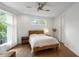 Bright bedroom features hardwood floors, a wooden platform bed and large windows with sheer curtains at 670 Willoughby Ne Way, Atlanta, GA 30312