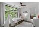 bedroom with bright white walls, ceiling fan and a tent under a window looking out onto trees at 670 Willoughby Ne Way, Atlanta, GA 30312