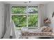 Bright bedroom with hardwood floors, large windows and view of lush greenery at 670 Willoughby Ne Way, Atlanta, GA 30312