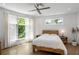 Bright bedroom with natural light, hardwood floors, a ceiling fan, and a view of the backyard at 670 Willoughby Ne Way, Atlanta, GA 30312