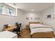 Simple bedroom with a desk, natural light, and hardwood floors at 670 Willoughby Ne Way, Atlanta, GA 30312