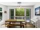 Dining area with a wooden table, bench seating, and a view of the outdoor deck at 670 Willoughby Ne Way, Atlanta, GA 30312