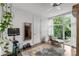 Bright workout area featuring a stationary bike, modern chair, and large windows with leafy views at 670 Willoughby Ne Way, Atlanta, GA 30312